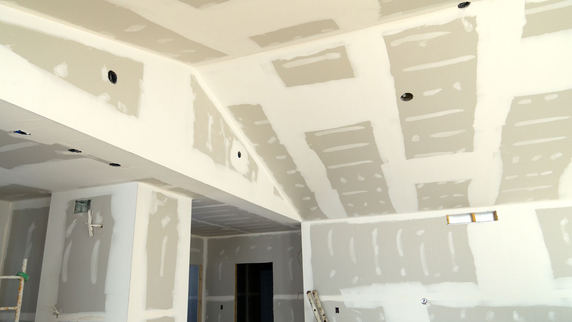 A room that is being painted with white paint