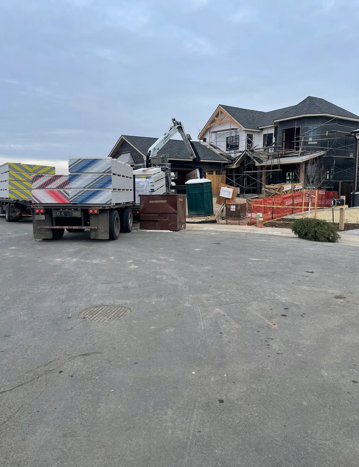 A truck parked in front of a house under construction