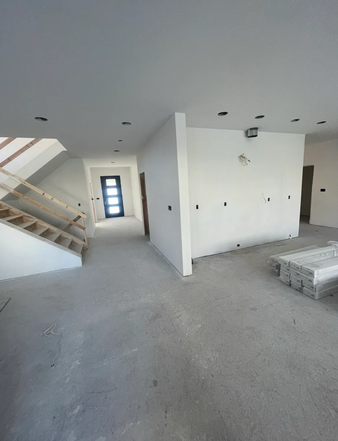 An empty room with stairs and a window